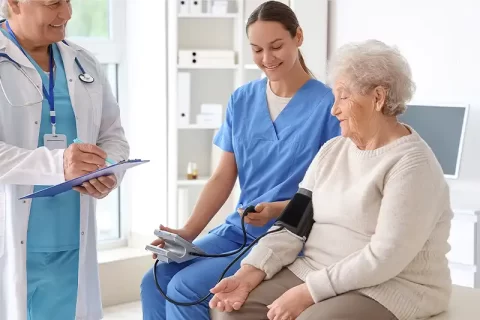 elderly woman with carer and doctor elderly woman with carer and doctor