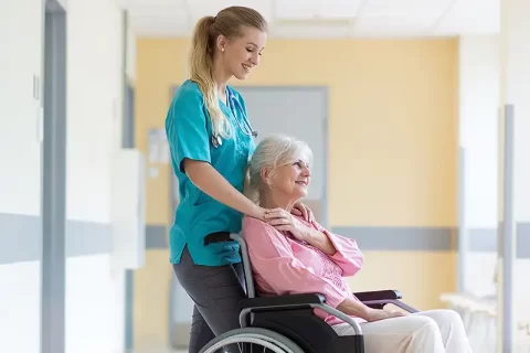 smiling woman in hospital with carer smiling woman in hospital with carer